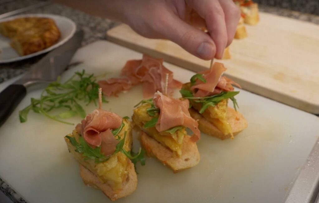 Mini tortilla snack with Jamón Serrano and arugula