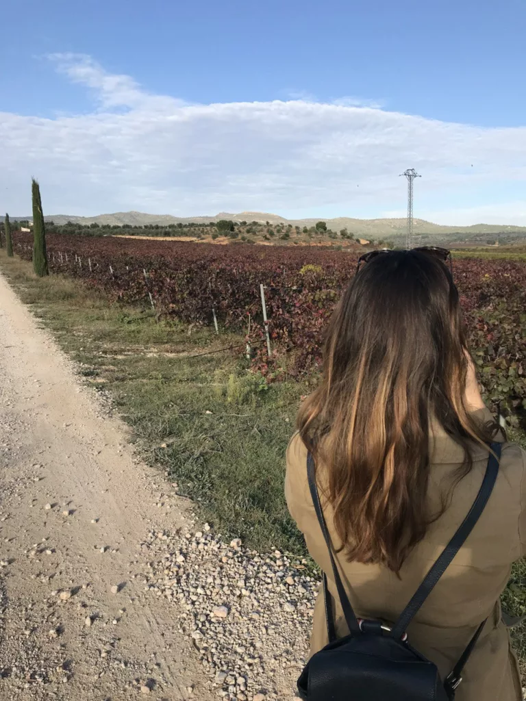 Nadia near Spanish vineyard on a road trip