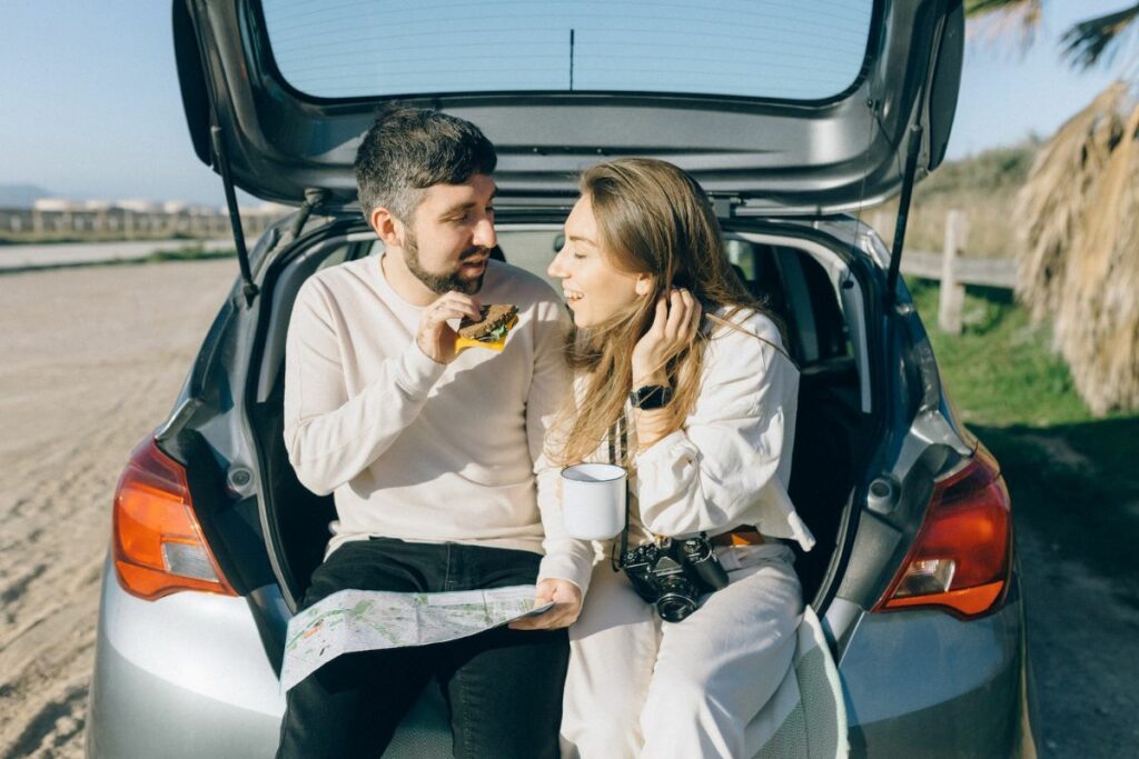 Couple eating on road trip